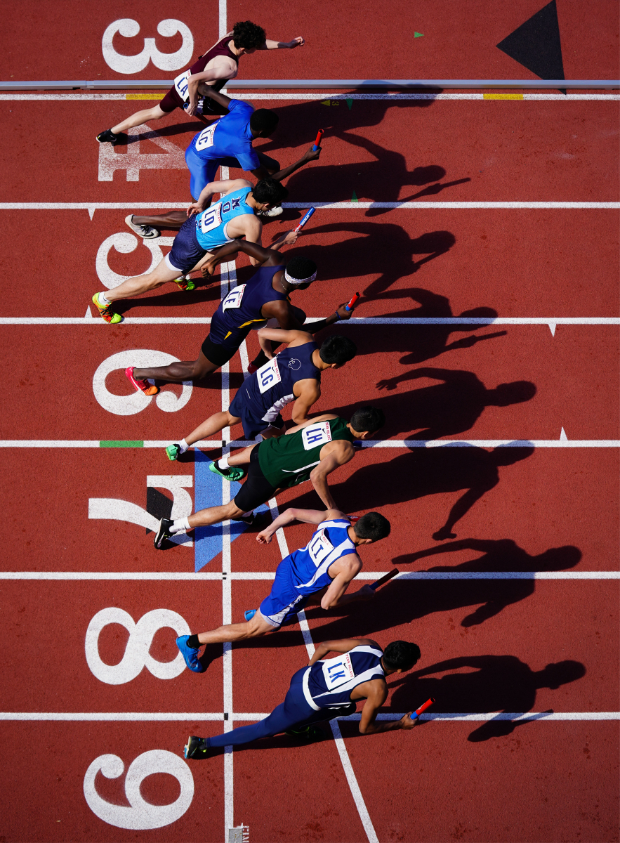 Runners begin a heat of the High School Boys 4x400 meter relay during the 125th running of the Penn Relays at Franklin Field in Philadelphia, Pa. on April 27, 2019. Note: This photograph was named the 2019 Associate College Press Sports Photograph of the Year.