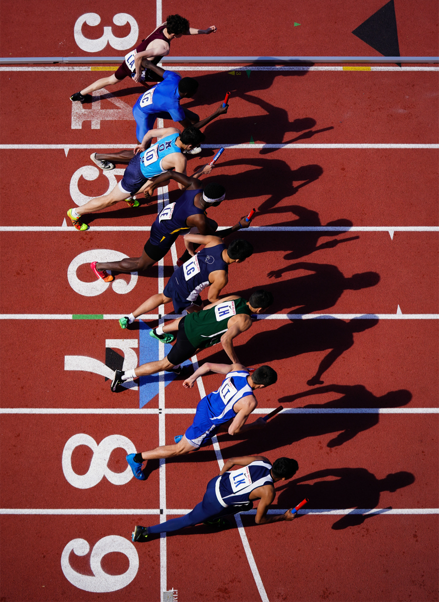 Runners begin a heat of the High School Boys 4x400 meter relay during the 125th running of the Penn Relays at Franklin Field in Philadelphia, Pa. on April 27, 2019. Note: This photograph was named the 2019 Associate College Press Sports Photograph of the Year.