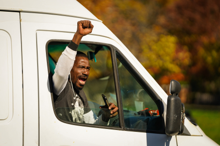 A man cheers outside of his van minutes after national news organizations projected that Joe Biden had won the 2020 election in Philadelphia, Pa. on Nov. 7, 2020.