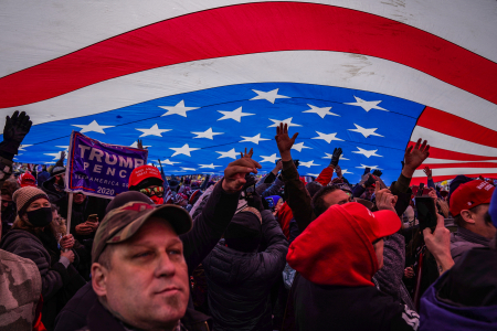 Supporters of President Donald Trump stand under a large American flag during a Stop the Steal rally in Washington, D.C. on Jan. 6, 2021.