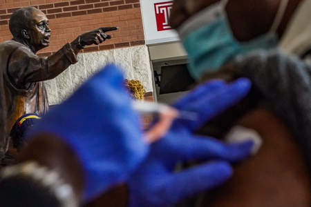 A woman receives the Moderna COVID-19 vaccine at the Black Doctors COVID-19 Consortium's vaccination clinic at Temple University's Licouras Center in Philadelphia, Pa. on Feb. 20, 2021.