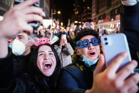 A couple takes videos with their cell phones as the ball drops during New Year's Eve Celebrations at Times Square in New York, N.Y. on Dec. 31, 2020.