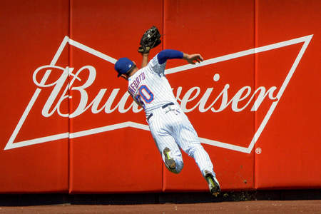 New York Mets outfielder Michael Conforto makes a diving catch during a game against the New York Yankees at Citi Field in Queens, N.Y. on Sept. 19, 2015.