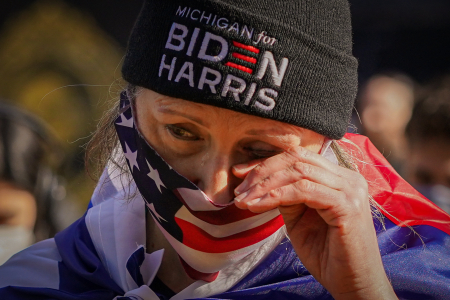 Liane Kufchok from Michigan wipes away a tear during President Joe Biden's inaugural address at Black Lives Matter Plaza in Washington, D.C. on Jan. 20, 2021. 