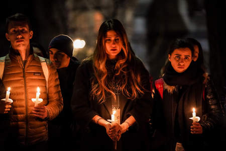 Community members observe a moment of silence to mourn the passengers who died while aboard Ukraine International Airlines Flight 752, which was shot down by Iranian missiles, on the University of Pennsylvania campus in Philadelphia, Pa. on Jan. 15, 2020.