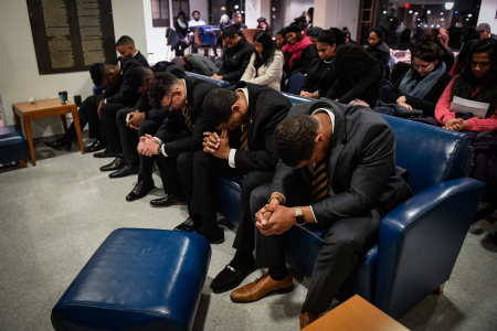 Residents of W.E.B Du Bois College House pray during a ceremony in honor of Martin Luther King Jr. Day in Philadelphia, Pa. on Jan. 21, 2019.