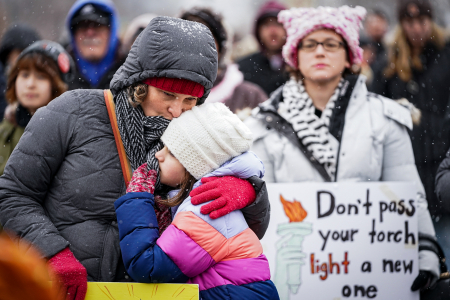 A mother kisses her daughter during the annual Women's March on Philadelphia outside the Philadelphia Museum of Art in Philadelphia, Pa. on Jan. 19, 2020.