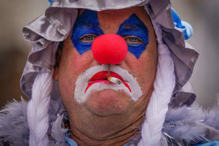 A man smokes a cigarette during a protest in response to Philadelphia's cancelling of the annual Mummer's Day parade, an event to celebrate the beginning of the new year, in Philadelphia, Pa. on Jan. 1, 2021.