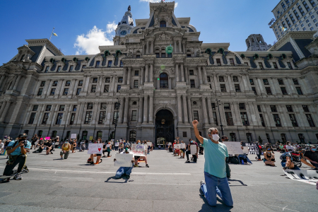 Demonstrators kneel for eight minutes and 46 seconds, the amount of time that Minneapolis Police officer Derek Chauvin knelt on George Floyd's neck, during a protest in front of the Philadelphia City Hall building in Philadelphia, Pa. on May 30, 2020.