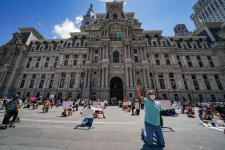 Demonstrators kneel for eight minutes and 46 seconds, the amount of time that Minneapolis Police officer Derek Chauvin knelt on George Floyd's neck, during a protest in front of the Philadelphia City Hall building in Philadelphia, Pa. on May 30, 2020.