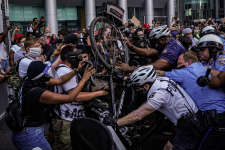 Philadelphia Police officers attempt to push protesters back with a bicycle in Philadelphia, Pa on May 30, 2020.