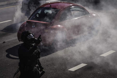 A SWAT team officer instructs protesters to leave Interstate 676 after throwing tear gas into the crowd in Philadelphia, Pa. on June 1, 2020.