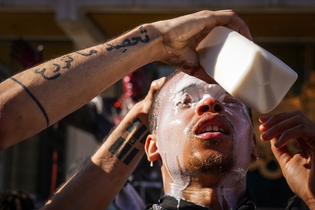 A protester has milk poured into his eyes after  Philadelphia Police officers used pepper spray and tear gas to disperse crowds in Philadelphia, Pa. on May 30, 2020.