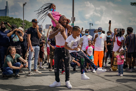 A father and his children dance at the conclusion of a protest in Philadelphia, Pa. on June 6, 2020.