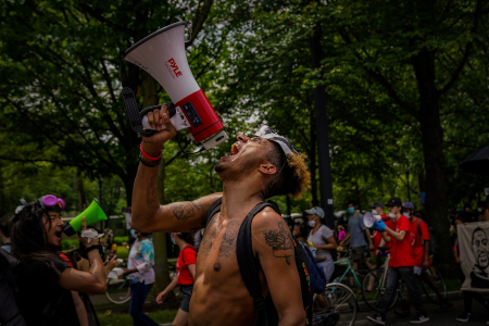 A protester screams a chant into a megaphone on the Benjamin Franklin Parkway in Philadelphia, Pa. on June 6, 2020.