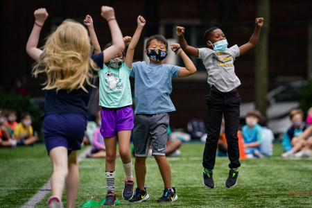 Campers in the seven to eight-year-old division celebrate after winning a tic-tac-toe challenge during morning assembly on Aug. 6, 2020.