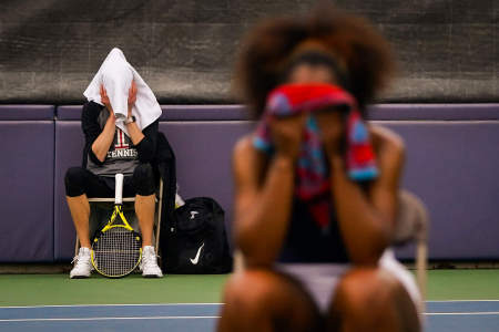 Temple University's Cecilia Castelli (left) and the University of Pennsylvanias Gibson Thomas cover their faces with towels after losing their respective matches at Hamlin Tennis Center in Philadelphia, Pa. on April 14, 2021.