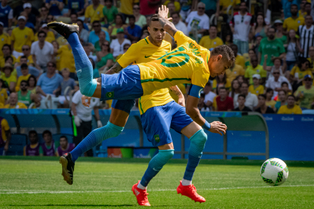 Brazil forward Neymar Jr. jumps over Honduras goalkeeper Luis Lopez before scoring a goal during the men's soccer semifinal at the Rio 2016 Summer Olympic Games at the Maracana Stadium in Rio de Janeiro, Brazil on Aug. 17, 2016.