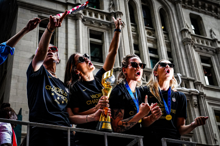 (Left to right) Megan Rapinoe, Alex Morgan, Alyssa Naeher, and Allie Long of the United States womens soccer team sing during a ticker tape parade to celebrate their FIFA Women's World Cup victory along Broadway's Canyon of Heroes in New York, N.Y. on July 10, 2019.