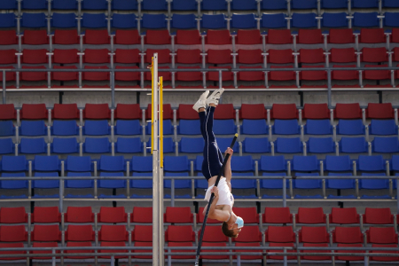 Thomas Conboy of Villanova University competes in the men's pole vault in front of empty seats while wearing a face mask at Franklin Field in Philadelphia, Pa. on April 3, 2021. 