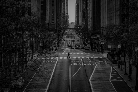 A man crosses an empty 42nd Street during the evening rush hour in New York, N.Y. on March 26, 2020. New York City was on lockdown as it had become the epicenter of the COVID-19 pandemic in the United States.