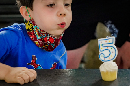 A camper in the four to five-year-old division blows out a candle during his fifth birthday celebration on July 29, 2020.